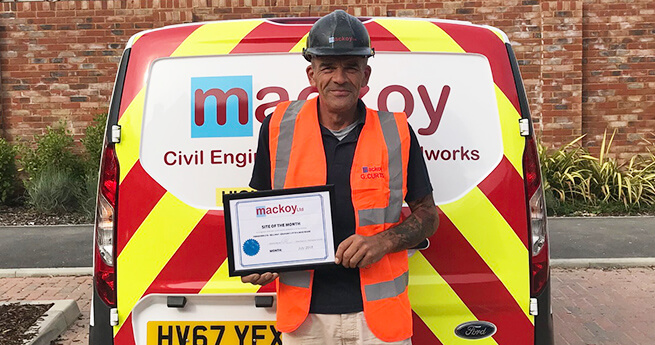 Mackoy Ltd July Site of the Month Winner in Front of Branded Groundworks and Civil Engineering Van