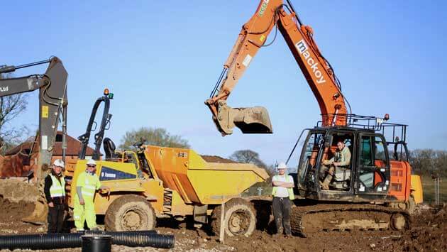 Groundworkers on site with Mackoy Plant Machinery for new Bellway contract in Fair Oak