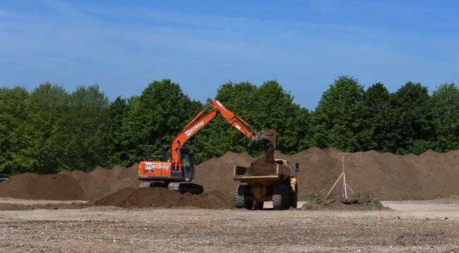 Site Clearance with Mackoy Plant Machinery Excavator loading soil onto dumper