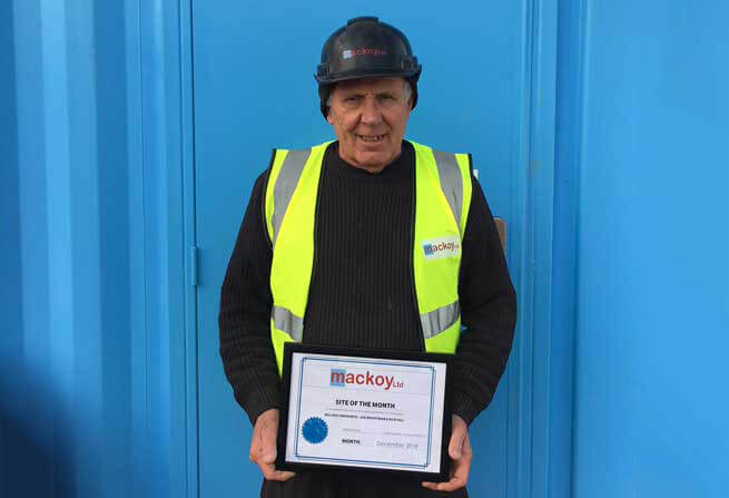 Site of the month December award winner standing in front of blue container