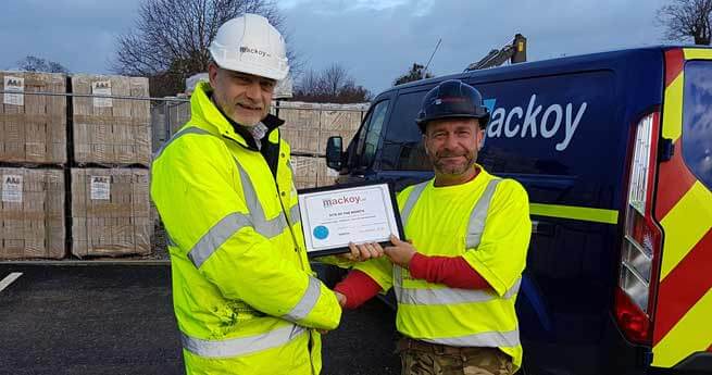 Site of the month November winner with award in front of Mackoy van